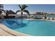 Inviting curved pool with surrounding lounge chairs at 660 Island Way # 1005, Clearwater Beach, FL 33767