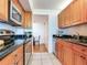 Updated kitchen with wood cabinets, granite counters, and stainless steel appliances at 660 Island Way # 1005, Clearwater Beach, FL 33767
