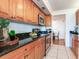 Modern kitchen with wood cabinets, granite countertops, and stainless steel appliances at 660 Island Way # 1005, Clearwater Beach, FL 33767