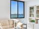 Living room with water views and built-in shelving at 660 Island Way # 1005, Clearwater Beach, FL 33767