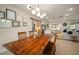 Bright dining area with a long wooden table and modern light fixture at 1013 N Habana Ave, Tampa, FL 33607