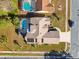 An aerial view showcasing a single Gathering home with a pool and solar panels at 10277 Rosetti Ct, Spring Hill, FL 34608