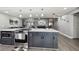 Modern kitchen with large island, stainless steel appliances, and dark gray cabinetry at 10277 Rosetti Ct, Spring Hill, FL 34608