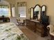 Bright Primary bedroom with large dresser and sitting area at 10626 Restoration Ter, Bradenton, FL 34212
