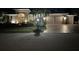 Night view of home with three-car garage and landscape lighting at 10626 Restoration Ter, Bradenton, FL 34212