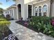 Landscaped walkway leading to the home's grand entrance at 10626 Restoration Ter, Bradenton, FL 34212