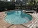 Inviting screened pool and spa with brick pavers at 10626 Restoration Ter, Bradenton, FL 34212
