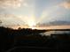 Sunset over calm water with distant houses at 10626 Restoration Ter, Bradenton, FL 34212