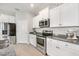 Modern kitchen featuring stainless steel appliances and granite countertops at 1089 Manzanar Pl, Wesley Chapel, FL 33543