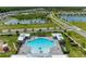 Community pool with surrounding houses and green spaces at 10947 Osprey Glade Ter, Land O Lakes, FL 34638