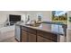 Kitchen island with granite countertops and stainless steel sink at 10947 Osprey Glade Ter, Land O Lakes, FL 34638