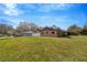 House side view, showcasing brick exterior and lawn at 11019 Hannaway Dr, Riverview, FL 33578