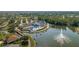 Aerial view of community center and lake with fountain, showcasing resort-style living at 1116 Flora Vista St, Trinity, FL 34655