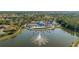 Community clubhouse with pool and fountain, surrounded by homes and green space at 1116 Flora Vista St, Trinity, FL 34655