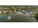 Aerial view of community clubhouse with pool, fountain, and lush landscaping at 1116 Flora Vista St, Trinity, FL 34655