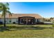 Private screened patio and backyard with lush grass at 1116 Flora Vista St, Trinity, FL 34655
