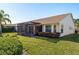 Home exterior showcasing a well-maintained lawn and screened porch at 1116 Flora Vista St, Trinity, FL 34655