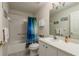 Bathroom with shower/tub combo, vanity, and beach-themed decor at 1116 Flora Vista St, Trinity, FL 34655