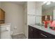 Bathroom features dark vanity, marble countertop, and a large mirror at 1116 Flora Vista St, Trinity, FL 34655