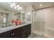 Double vanity bathroom with marble countertop and walk-in shower at 1116 Flora Vista St, Trinity, FL 34655