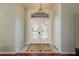 Bright entry with double doors, tile floor, and chandelier at 1116 Flora Vista St, Trinity, FL 34655