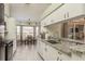 White kitchen cabinets, granite counters, and a breakfast nook at 1116 Flora Vista St, Trinity, FL 34655