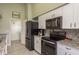 Sleek kitchen with black appliances and granite countertops at 1116 Flora Vista St, Trinity, FL 34655