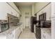 Modern kitchen with granite countertops and black appliances at 1116 Flora Vista St, Trinity, FL 34655