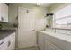 Laundry room with washer, dryer, and built-in cabinets at 1116 Flora Vista St, Trinity, FL 34655