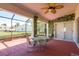 Covered patio with seating area, lush greenery, and ceiling fan at 1116 Flora Vista St, Trinity, FL 34655