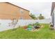 Landscaped backyard with a garden and white vinyl fence at 11714 Sunburst Marble Rd, Riverview, FL 33579