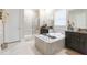 Spa-like bathroom with double sinks, large soaking tub, and shower at 11714 Sunburst Marble Rd, Riverview, FL 33579
