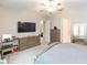Main bedroom with large TV, dresser, and access to other rooms at 11714 Sunburst Marble Rd, Riverview, FL 33579
