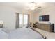 Bright bedroom with large windows, TV, and ample dresser storage at 11714 Sunburst Marble Rd, Riverview, FL 33579
