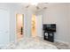 King-size bed with ensuite bathroom and tv at 11714 Sunburst Marble Rd, Riverview, FL 33579