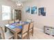 Bright dining room featuring a large table and modern light fixture at 11714 Sunburst Marble Rd, Riverview, FL 33579