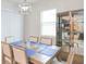 Elegant dining room with a glass-front cabinet and neutral color palette at 11714 Sunburst Marble Rd, Riverview, FL 33579