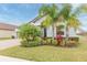 Two-story house with gray siding, palm trees, and well-manicured lawn at 11714 Sunburst Marble Rd, Riverview, FL 33579