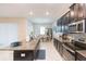 Modern kitchen with island, dark cabinets, and granite countertops at 11714 Sunburst Marble Rd, Riverview, FL 33579