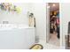 Bright laundry room with washer, dryer, and built-in shelving at 11714 Sunburst Marble Rd, Riverview, FL 33579