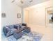 Living area with sectional sofa, ottomans, and area rug at 11714 Sunburst Marble Rd, Riverview, FL 33579