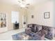 Living room with sectional sofa, ottomans, and built-in shelving at 11714 Sunburst Marble Rd, Riverview, FL 33579