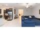 Living room with comfortable sectional sofa and view into hallway at 11714 Sunburst Marble Rd, Riverview, FL 33579