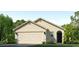 Single-story home with a two-car garage and attractive landscaping at 12016 Lansing Gln, Parrish, FL 34219