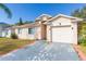 Tan one-story house with a two-car garage and small front yard at 13508 Prestwick Dr, Riverview, FL 33579