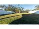 Spacious grassy backyard with white vinyl fence at 13735 Wineberry Dr, Dade City, FL 33525