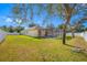 Spacious backyard with large trees and screened pool at 1503 River Ct, Tarpon Springs, FL 34689