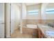 Bathroom with granite vanity, soaking tub and tile flooring at 1503 River Ct, Tarpon Springs, FL 34689