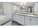 Double vanity bathroom with ample storage and a walk-in shower at 1621 Watermark Ne Cir # 1621, St Petersburg, FL 33702