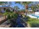 Relaxing community pool area with lush landscaping and wooden walkways at 1621 Watermark Ne Cir # 1621, St Petersburg, FL 33702